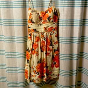 Cream colored dress with big orange flowers 
Zips, with hook, and ties-Adj strap